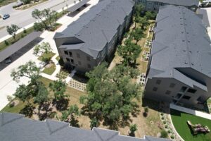 A multifamily complex with trees planted throughout the property